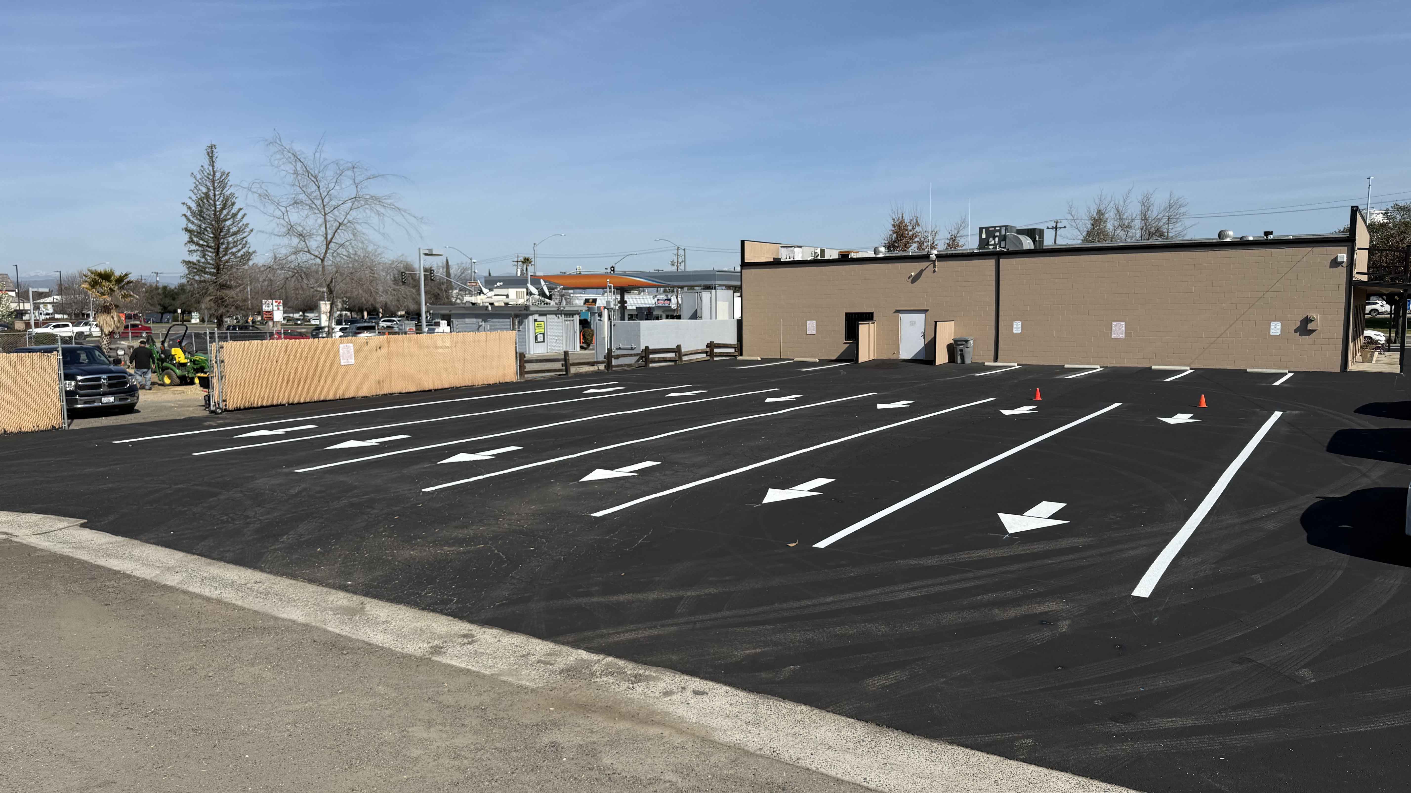 Fresh asphalt sealcoat applied to a parking area